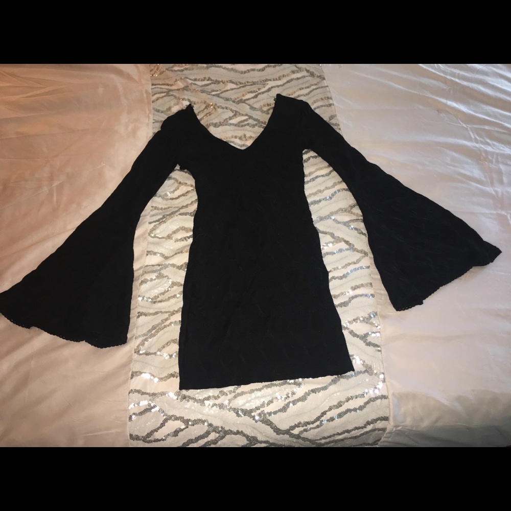 Very sexy black Bebe dress with bell sleeves.